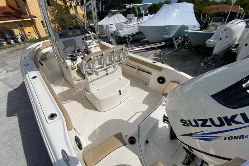 Slide: The Image of 2016 Pioneer 197 Sportfish boat with Suzuki engine, parked outdoors. - 13