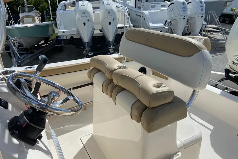Slide: The Image of 2016 Pioneer 197 Sportfish boat interior with steering wheel and cushioned seating. - 21
