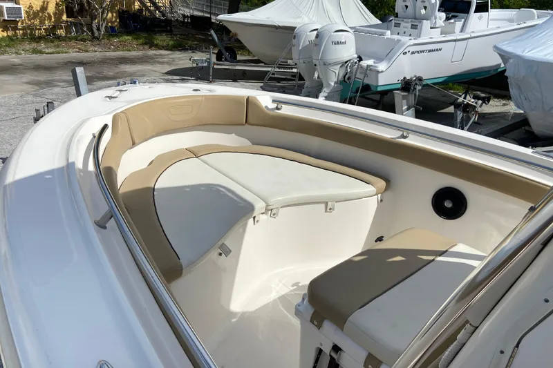 Slide: The Image of 2016 Pioneer 197 Sportfish boat interior with cushioned seating and storage area. - 26