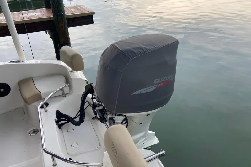 Slide: The Image of 2016 Pioneer 197 Sportfish boat with Suzuki outboard motor, docked on calm water. - 9