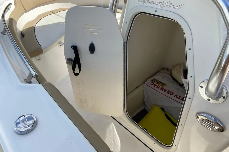 Slide: The Image of 2016 Pioneer 197 Sportfish boat storage compartment with safety gear and seating area. - 29