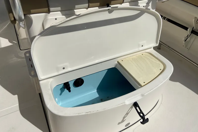 Slide: The Image of Open storage compartment on a 2016 Pioneer 197 Sportfish boat, featuring a blue interior. - 17