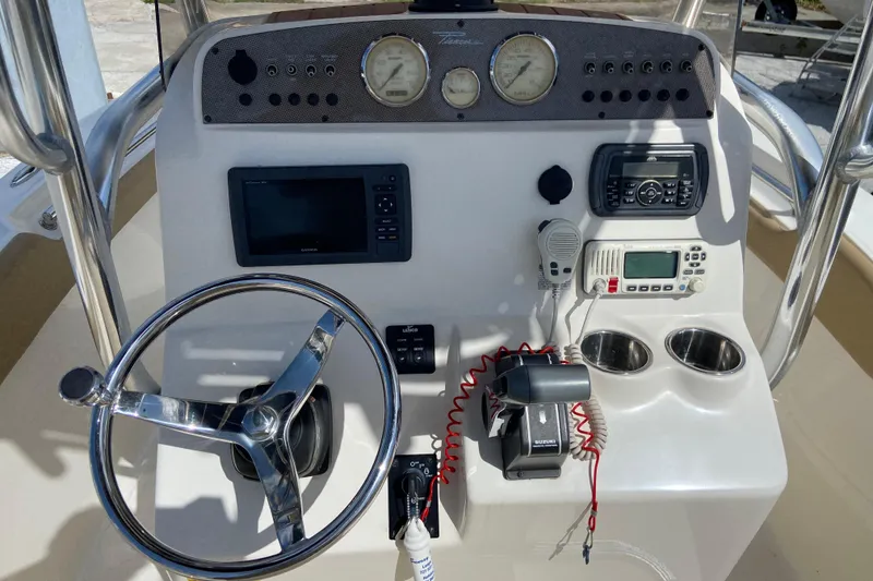 Slide: The Image of 2016 Pioneer 197 Sportfish boat console with steering wheel, gauges, and electronic controls. - 23