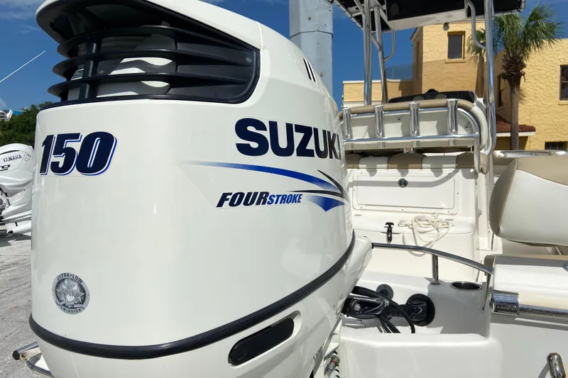Slide: The Image of 2016 Pioneer 197 Sportfish with Suzuki 150 Four Stroke engine, docked under clear sky. - 12