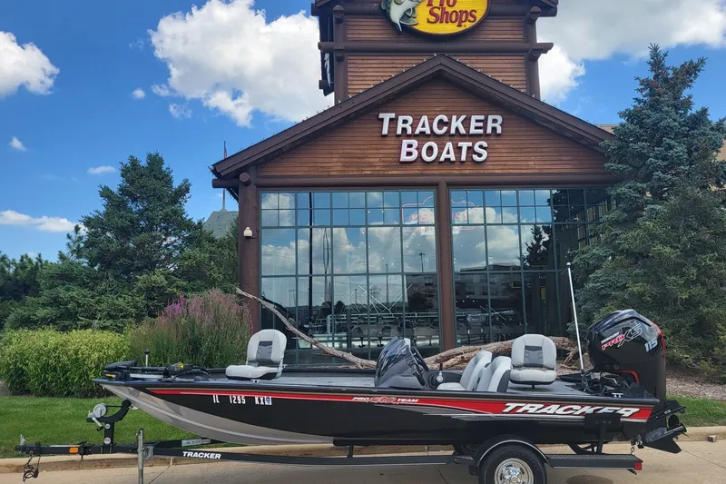 Slide: The Image of 2018 Tracker Pro Team 190 TX boat displayed outside Tracker Boats store. - 13