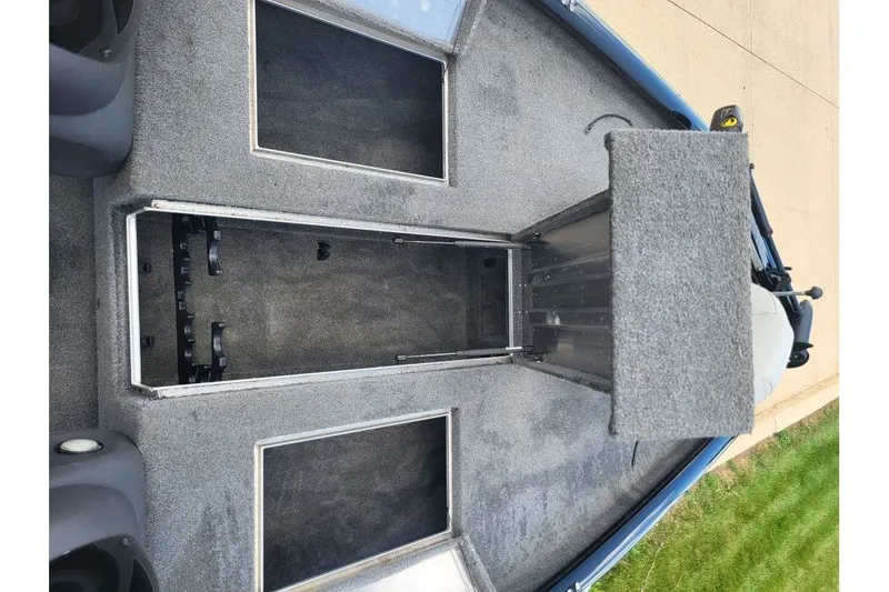 Slide: The Image of 2018 Tracker Pro Team 190 TX boat interior with open storage compartments. - 8