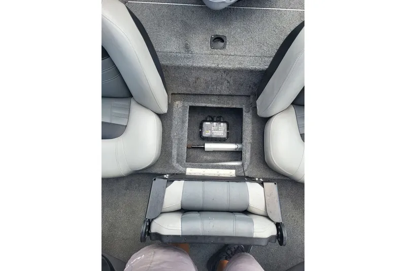 Slide: The Image of 2018 Tracker Pro Team 190 TX boat interior with storage compartment and seating. - 11