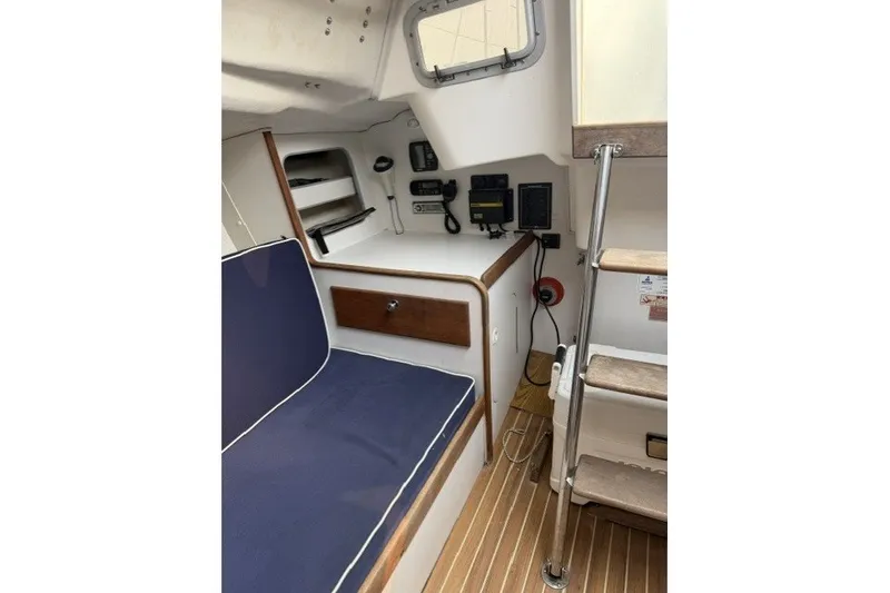 Slide: The Image of Interior of a 2001 J Boats J/105 sailboat, featuring seating and navigation equipment. - 16