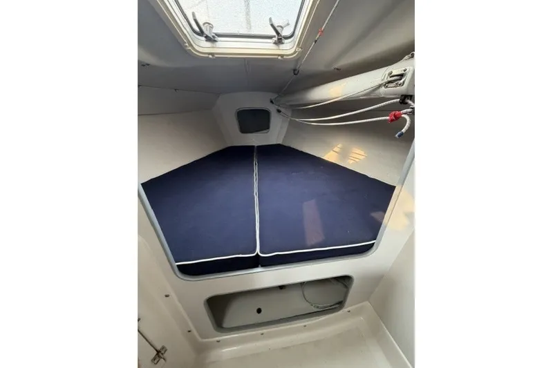 Slide: The Image of Interior cabin of a 2001 J Boats J/105 sailboat with blue cushions. - 18