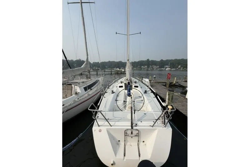 Slide: The Image of 2001 J Boats J/105 sailboat docked at a marina, viewed from the stern. - 1