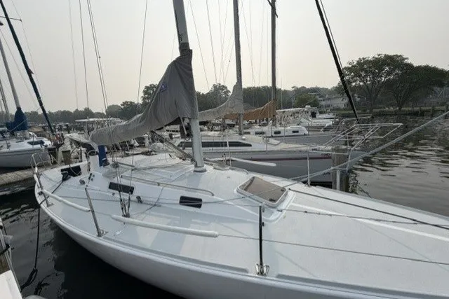 Slide: The Image of 2001 J Boats J/105 sailboat docked in a marina, surrounded by other vessels. - 5