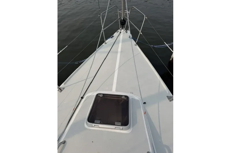 Slide: The Image of Bow view of 2001 J Boats J/105 sailboat, featuring deck and hatch details. - 12