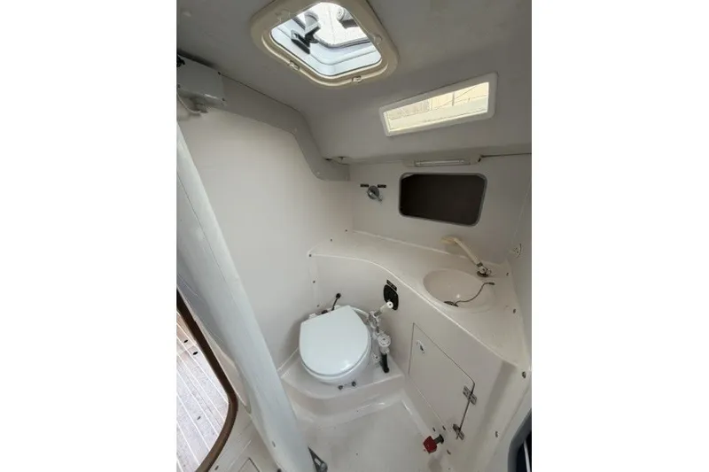 Slide: The Image of Interior of 2001 J Boats J/105 sailboat showing compact marine toilet and sink. - 19