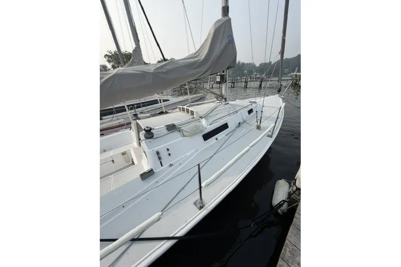 Slide: The Image of 2001 J Boats J/105 sailboat docked at a marina, featuring sleek white design. - 3