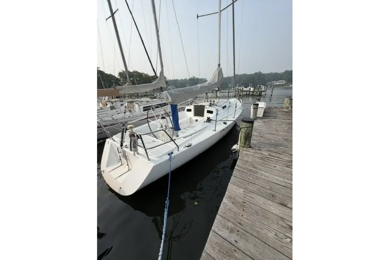 Slide: The Image of 2001 J Boats J/105 sailboat docked at a marina, side view. - 2