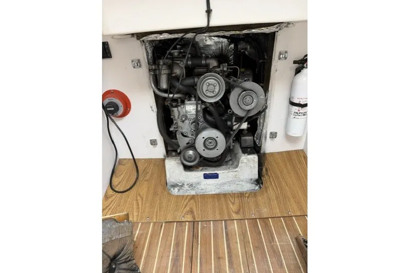 Slide: The Image of Engine compartment of a 2001 J Boats J/105 sailboat, featuring a visible engine and fire extinguisher. - 20