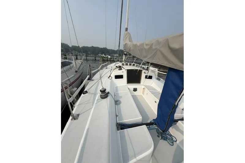 Slide: The Image of 2001 J Boats J/105 sailboat deck view at marina, featuring rigging and seating. - 11