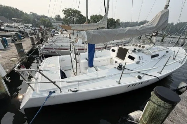 Slide: The Image of 2001 J Boats J/105 sailboat docked at a marina, covered mainsail, ready for sailing. - 4