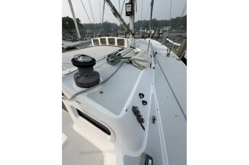 Slide: The Image of 2001 J Boats J/105 sailboat deck with winch and rigging in marina setting. - 9