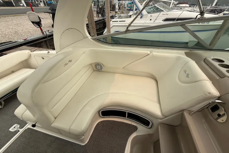 Slide: The Image of 2004 Sea Ray Sundancer 280 interior with cream leather seating and cup holders. - 7