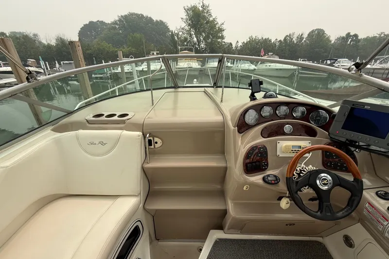 Slide: The Image of 2004 Sea Ray Sundancer 280 helm with steering wheel, gauges, and navigation equipment. - 9