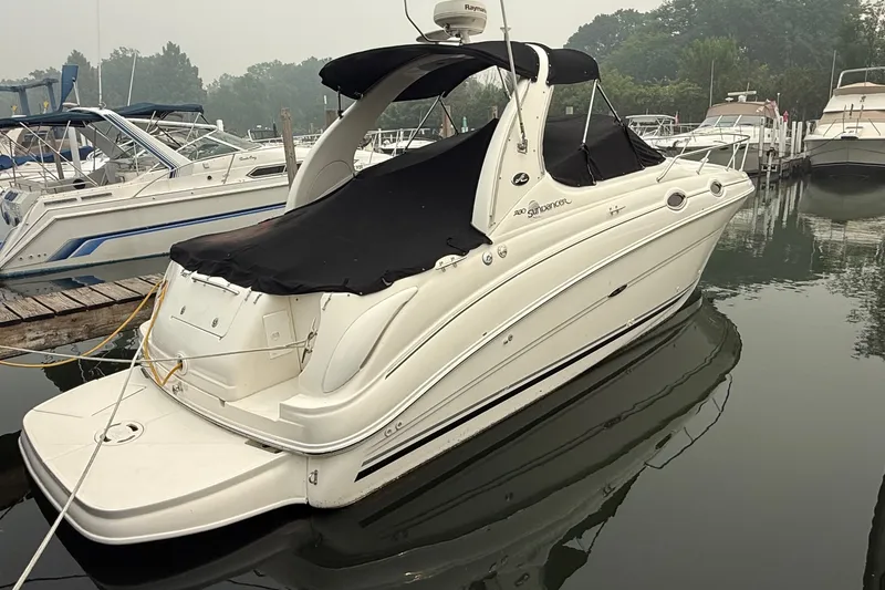 Slide: The Image of 2004 Sea Ray Sundancer 280 docked at marina, covered with black canvas. - 23