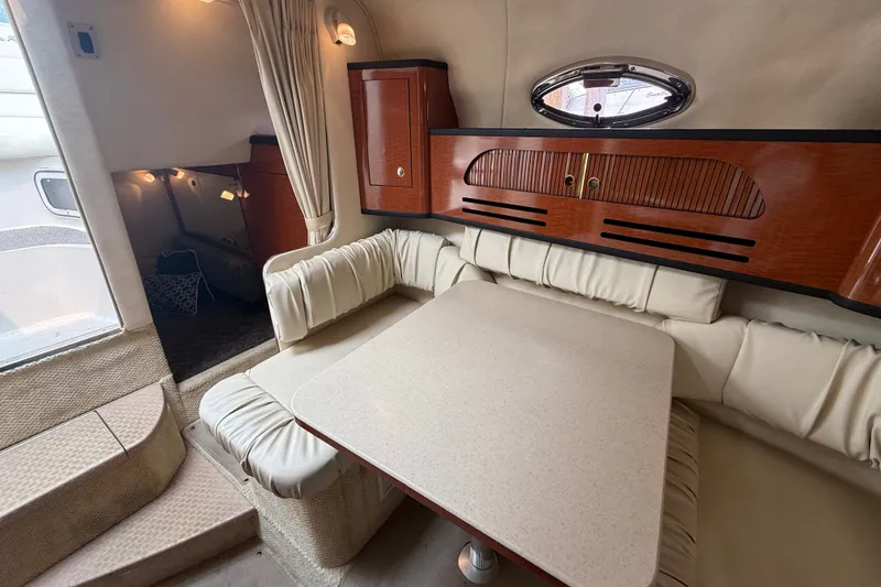 Slide: The Image of Interior of 2004 Sea Ray Sundancer 280 with cozy seating and elegant wood cabinetry. - 17