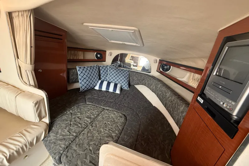 Slide: The Image of Interior cabin of 2004 Sea Ray Sundancer 280 with cozy bedding and entertainment system. - 15