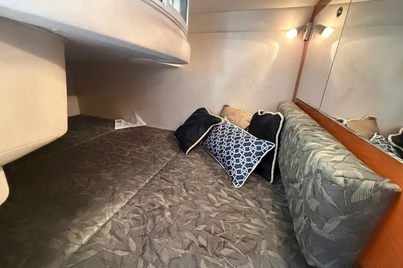 Slide: The Image of Interior cabin of 2004 Sea Ray Sundancer 280 with cozy bedding and decorative pillows. - 20