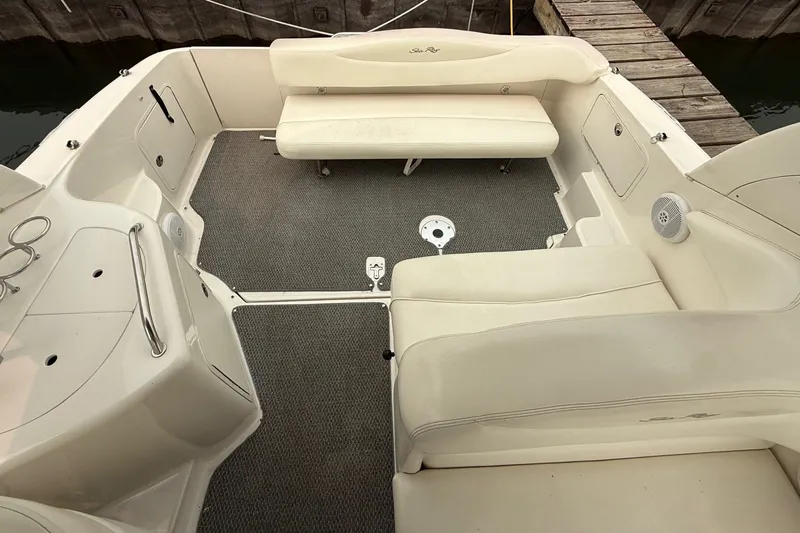 Slide: The Image of 2004 Sea Ray Sundancer 280 boat interior with beige seating and carpeted floor. - 5