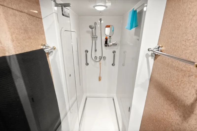 Slide: The Image of Luxurious shower area in a 2004 Cheoy Lee Flybridge yacht, featuring modern fixtures and amenities. - 39