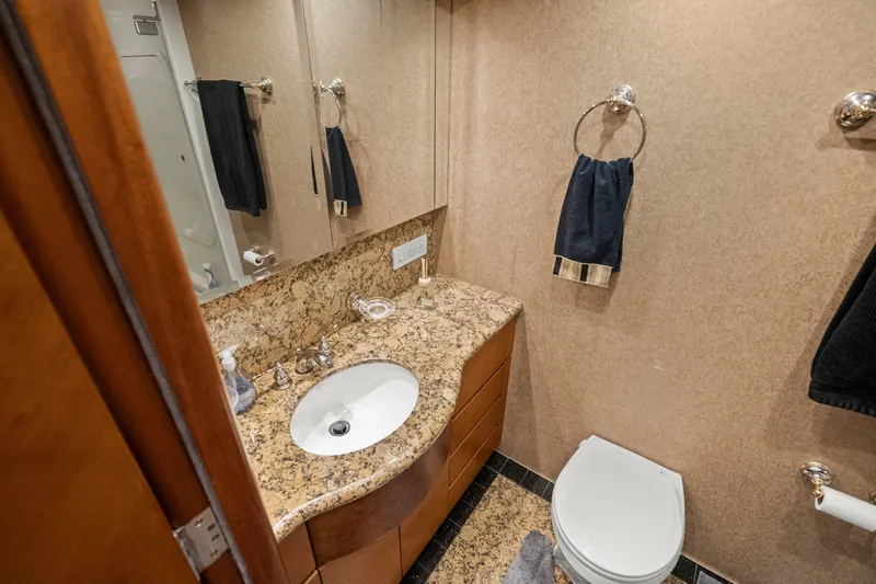 Slide: The Image of Luxurious 2004 Cheoy Lee Flybridge yacht bathroom with granite countertop and elegant fixtures. - 34