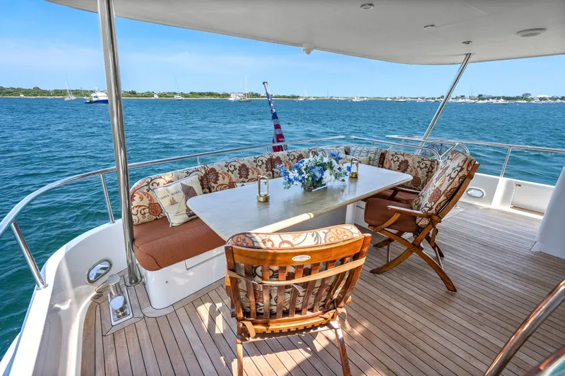 Slide: The Image of Luxurious 2004 Cheoy Lee Flybridge yacht deck with elegant seating and ocean view. - 8