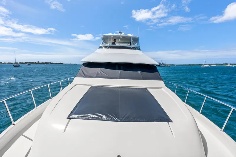 Slide: The Image of 2004 Cheoy Lee Flybridge yacht cruising on blue ocean under clear sky. - 10