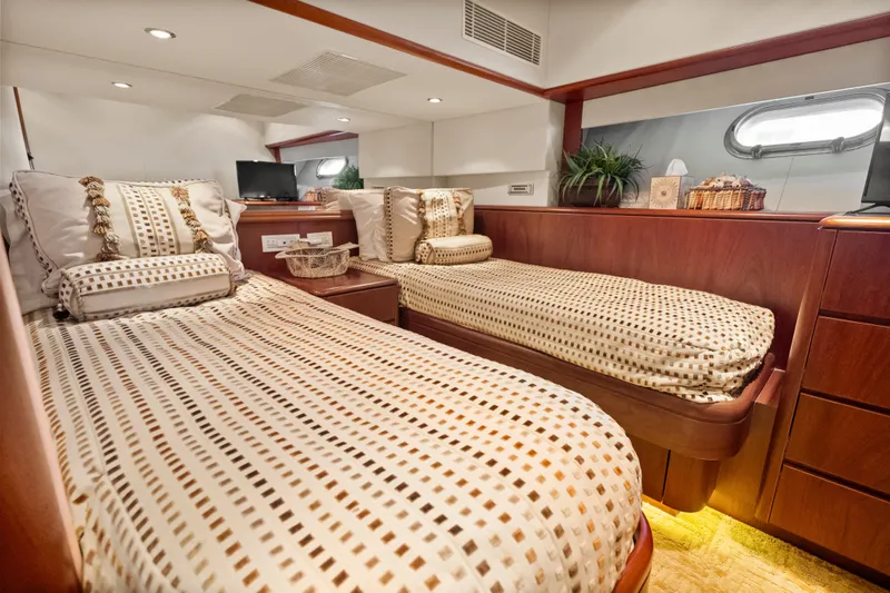 Slide: The Image of Luxurious 2004 Cheoy Lee Flybridge yacht cabin with twin beds and elegant decor. - 38