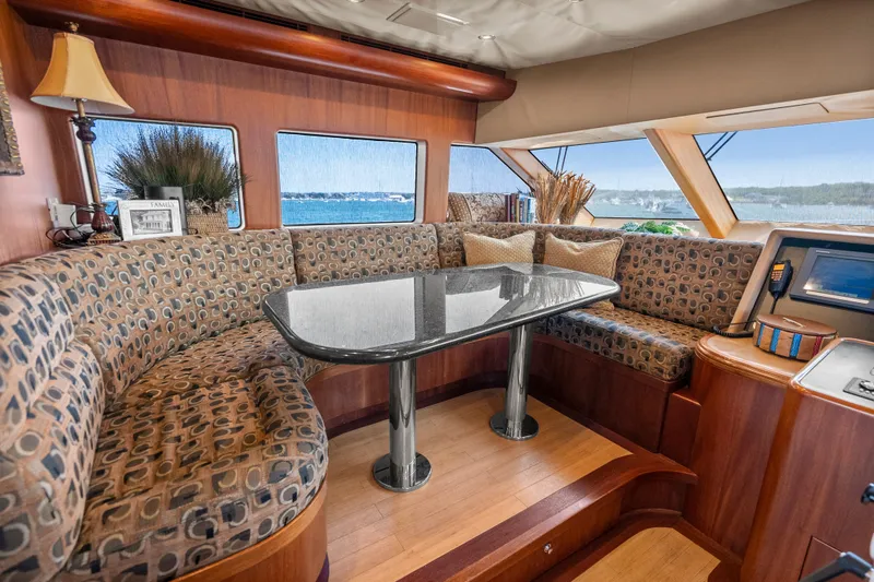 Slide: The Image of Luxurious 2004 Cheoy Lee Flybridge yacht interior with elegant seating and panoramic windows. - 29