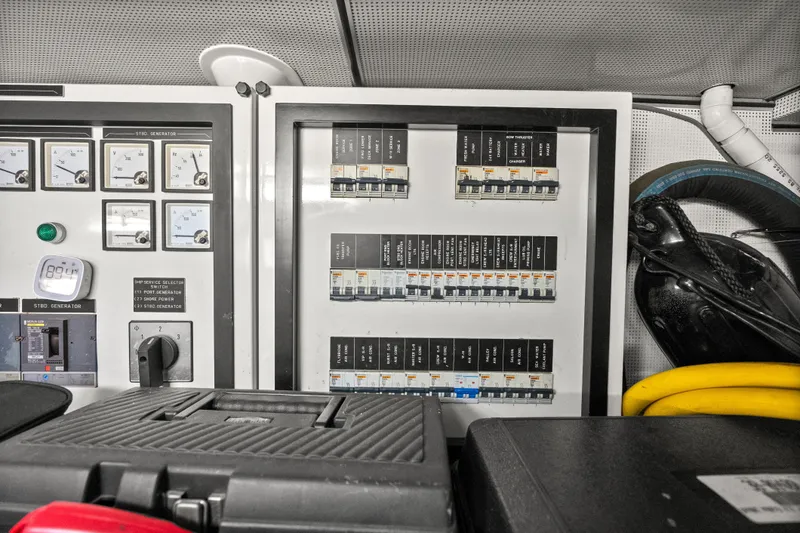 Slide: The Image of Electrical panel on a 2004 Cheoy Lee Flybridge yacht, featuring gauges and circuit breakers. - 46