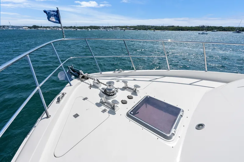 Slide: The Image of 2004 Cheoy Lee Flybridge yacht deck overlooking calm blue waters. - 11