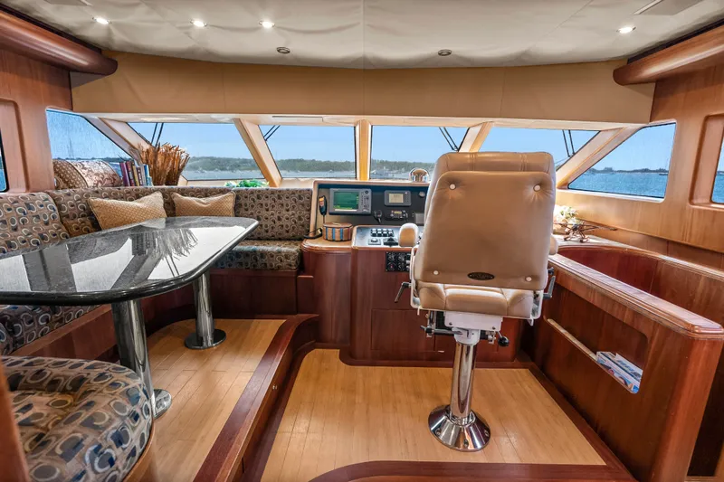Slide: The Image of Luxurious 2004 Cheoy Lee Flybridge interior with helm, seating, and panoramic windows. - 27