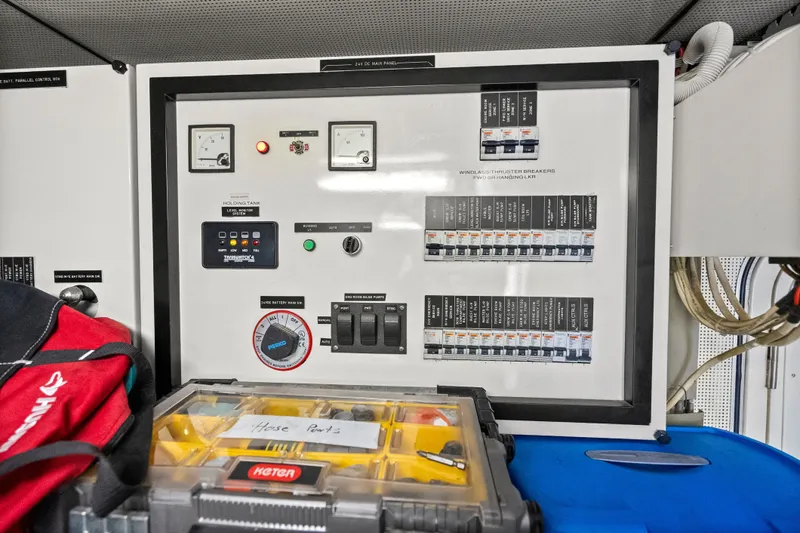 Slide: The Image of Electrical panel on a 2004 Cheoy Lee Flybridge yacht with labeled switches and meters. - 45