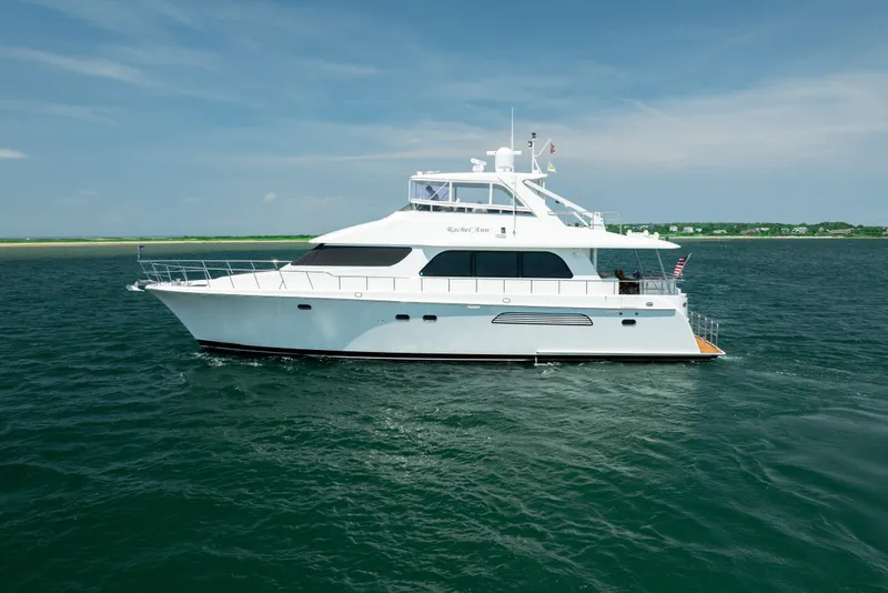 The Image of 2004 Cheoy Lee Flybridge yacht cruising on open water under clear skies. - 1
