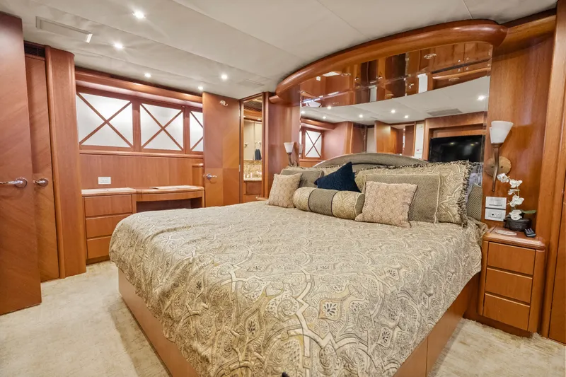 Slide: The Image of Luxurious 2004 Cheoy Lee Flybridge yacht bedroom with elegant wood finishes and plush bedding. - 32