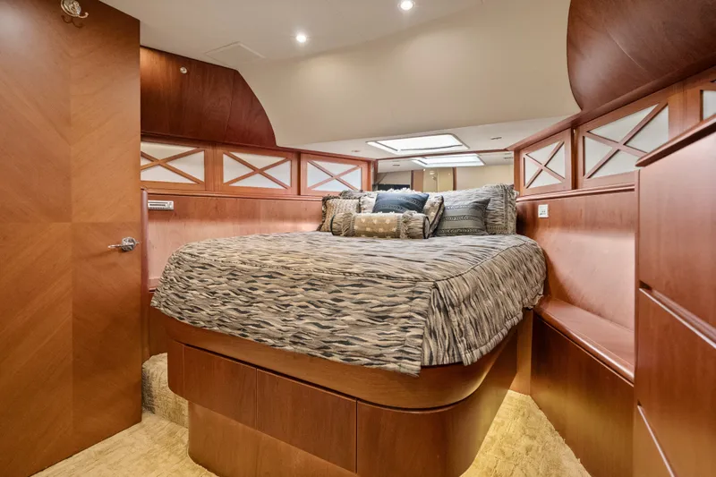 Slide: The Image of Luxurious 2004 Cheoy Lee Flybridge yacht bedroom with elegant wood finishes and cozy bedding. - 35