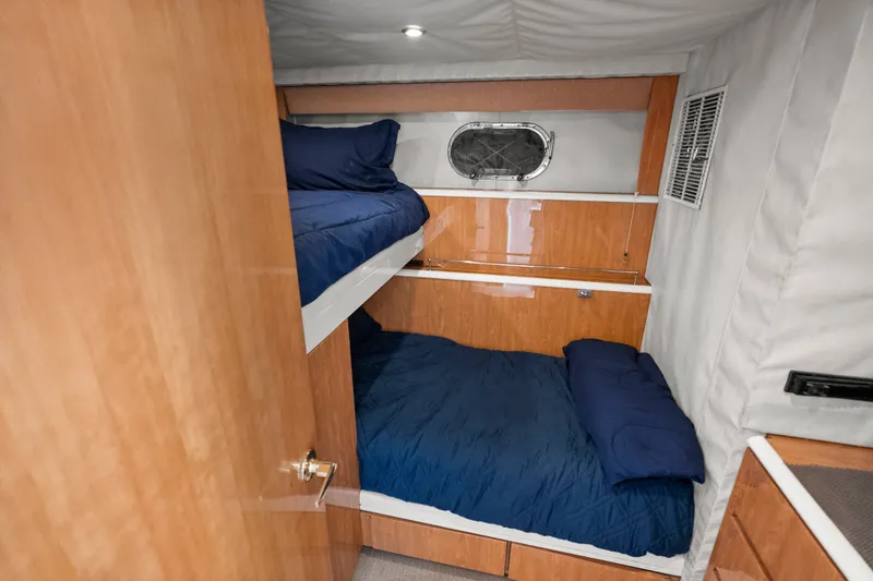 Slide: The Image of 2004 Cheoy Lee Flybridge cabin with bunk beds and wooden interior. - 40