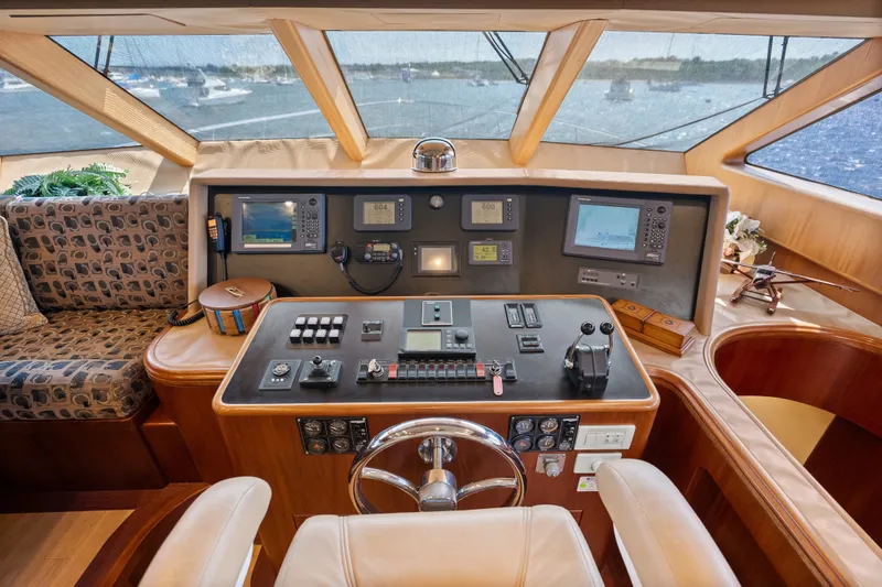 Slide: The Image of Luxurious 2004 Cheoy Lee Flybridge yacht helm with advanced navigation controls and panoramic views. - 28