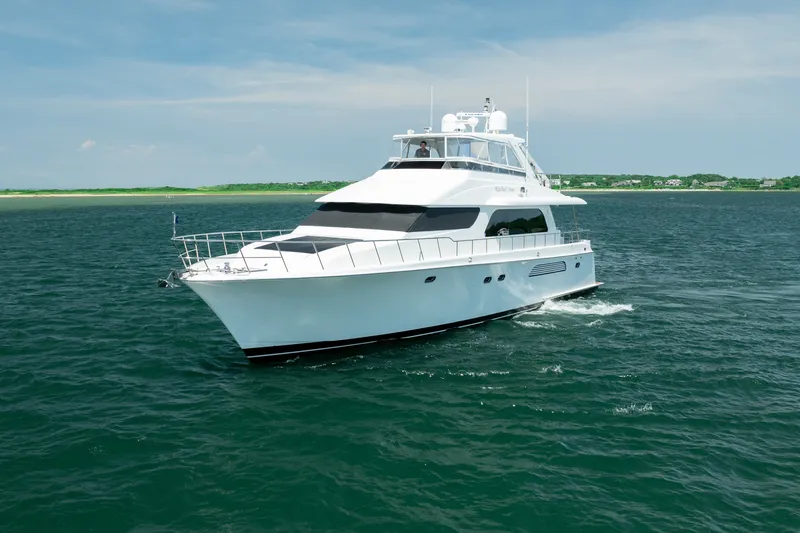 Slide: The Image of 2004 Cheoy Lee Flybridge yacht cruising on open water under clear skies. - 2