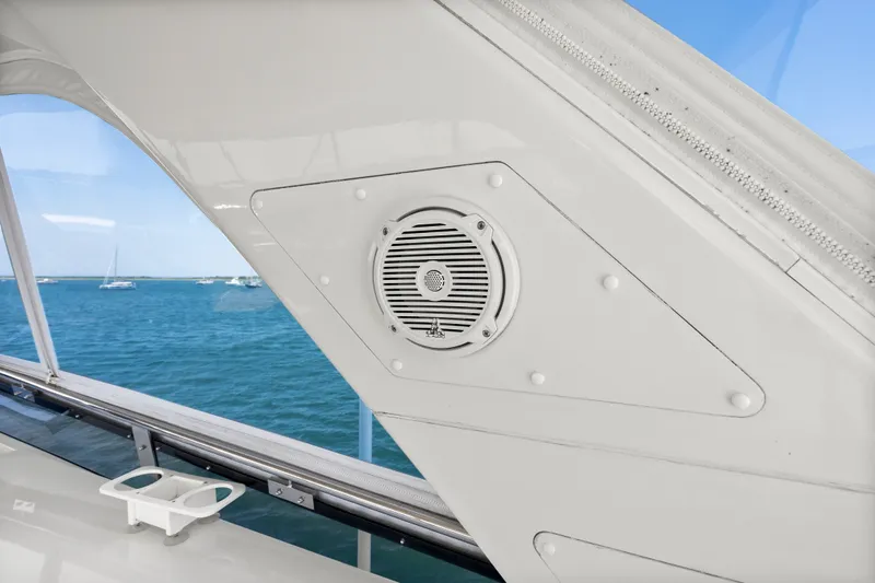 Slide: The Image of 2004 Cheoy Lee Flybridge yacht interior with speaker, overlooking ocean and sailboats. - 14