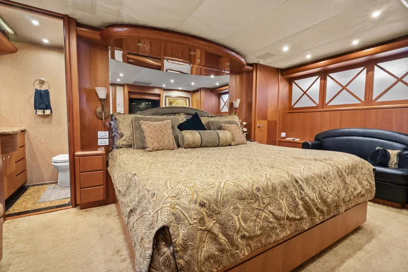 Slide: The Image of Luxurious 2004 Cheoy Lee Flybridge yacht bedroom with elegant decor and plush bedding. - 33