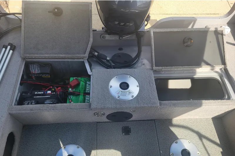 Slide: The Image of The image shows the interior of a 2014 G3 Angler V172 FS boat with storage compartments and motor. - 6