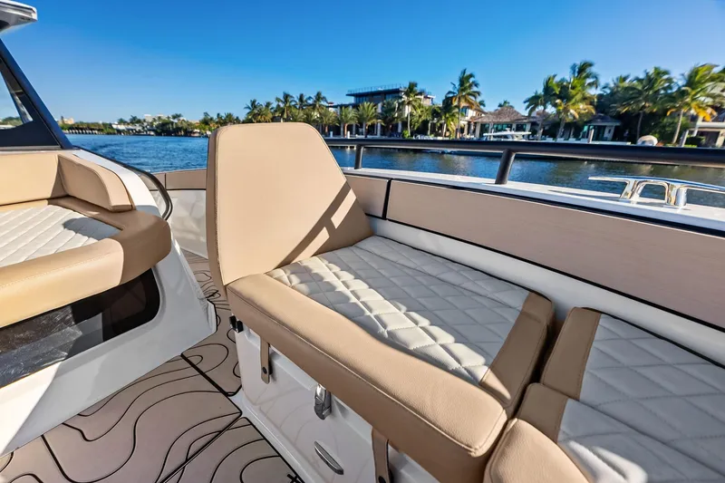 Slide: The Image of Luxurious seating on 2025 Zodiac X10CC boat with scenic waterfront view. - 44